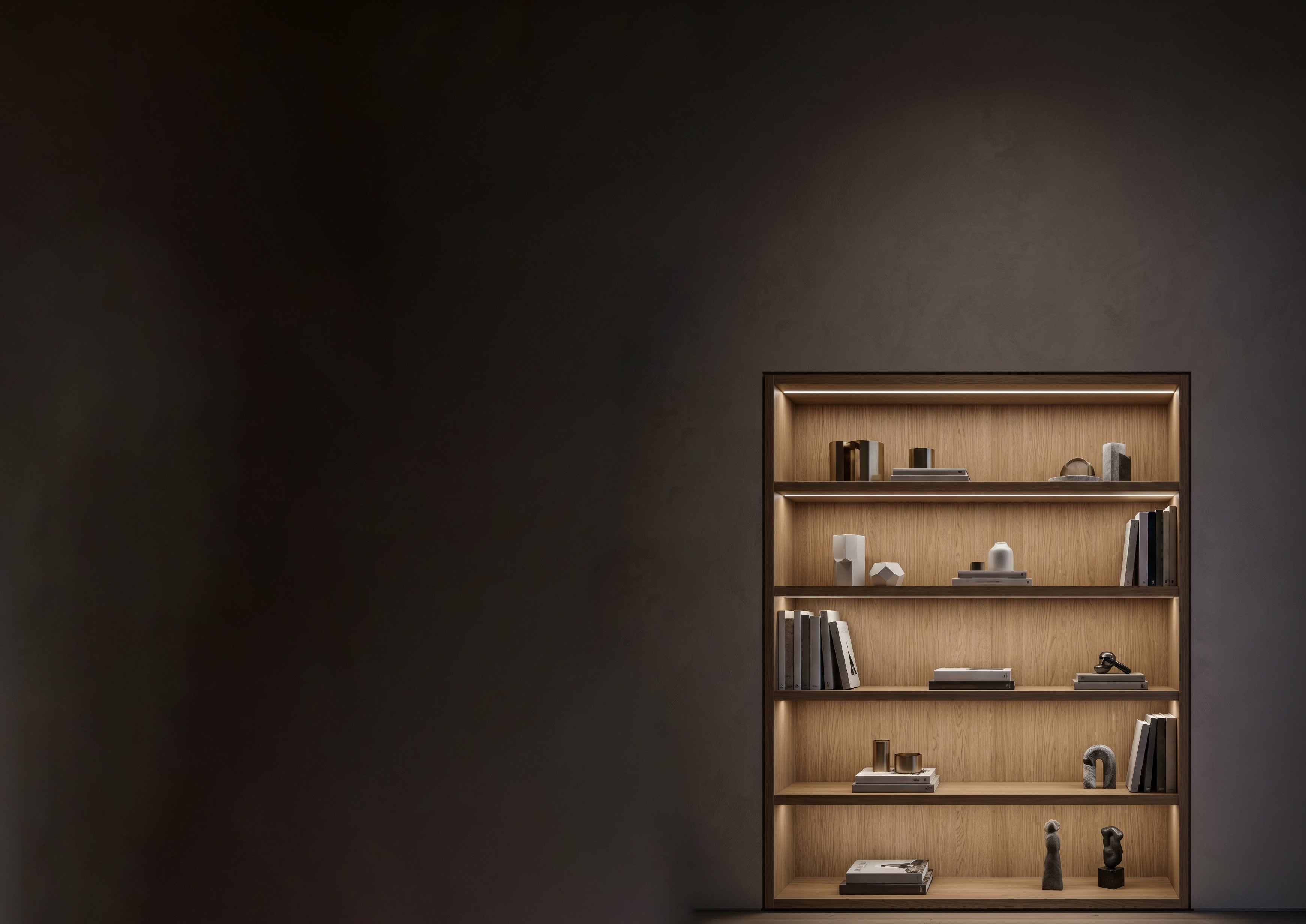 Dark fitted interior with warm illuminated timber display shelving