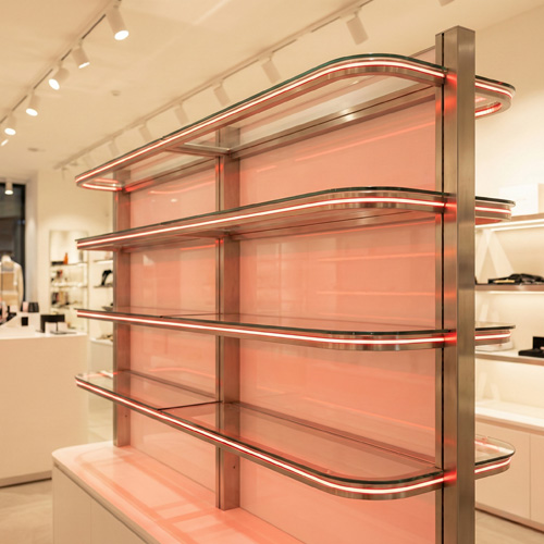 NEOLINEAR Nano 3mm LED neon strip inside a glass jewellery display cabinet — warm white retail showcase lighting